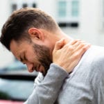 Man Suffering From Pinched Nerve In Neck