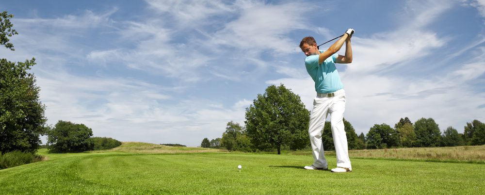 A man swinging a golf club