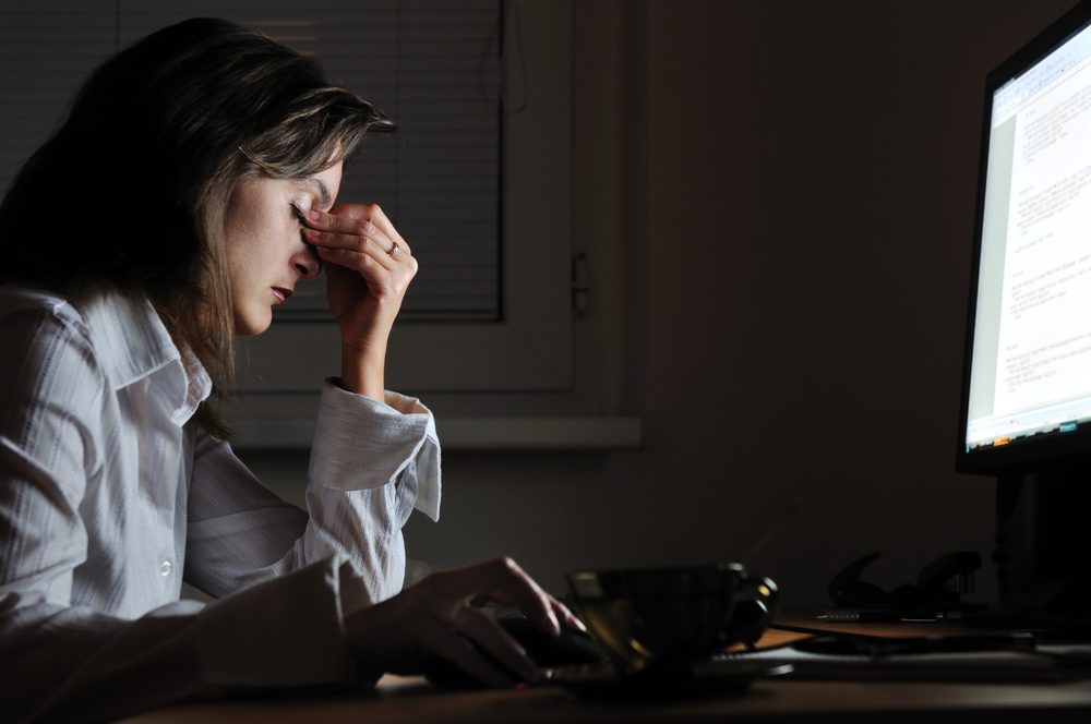 A depressed woman working at a desk