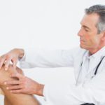 doctor examining a patients knee